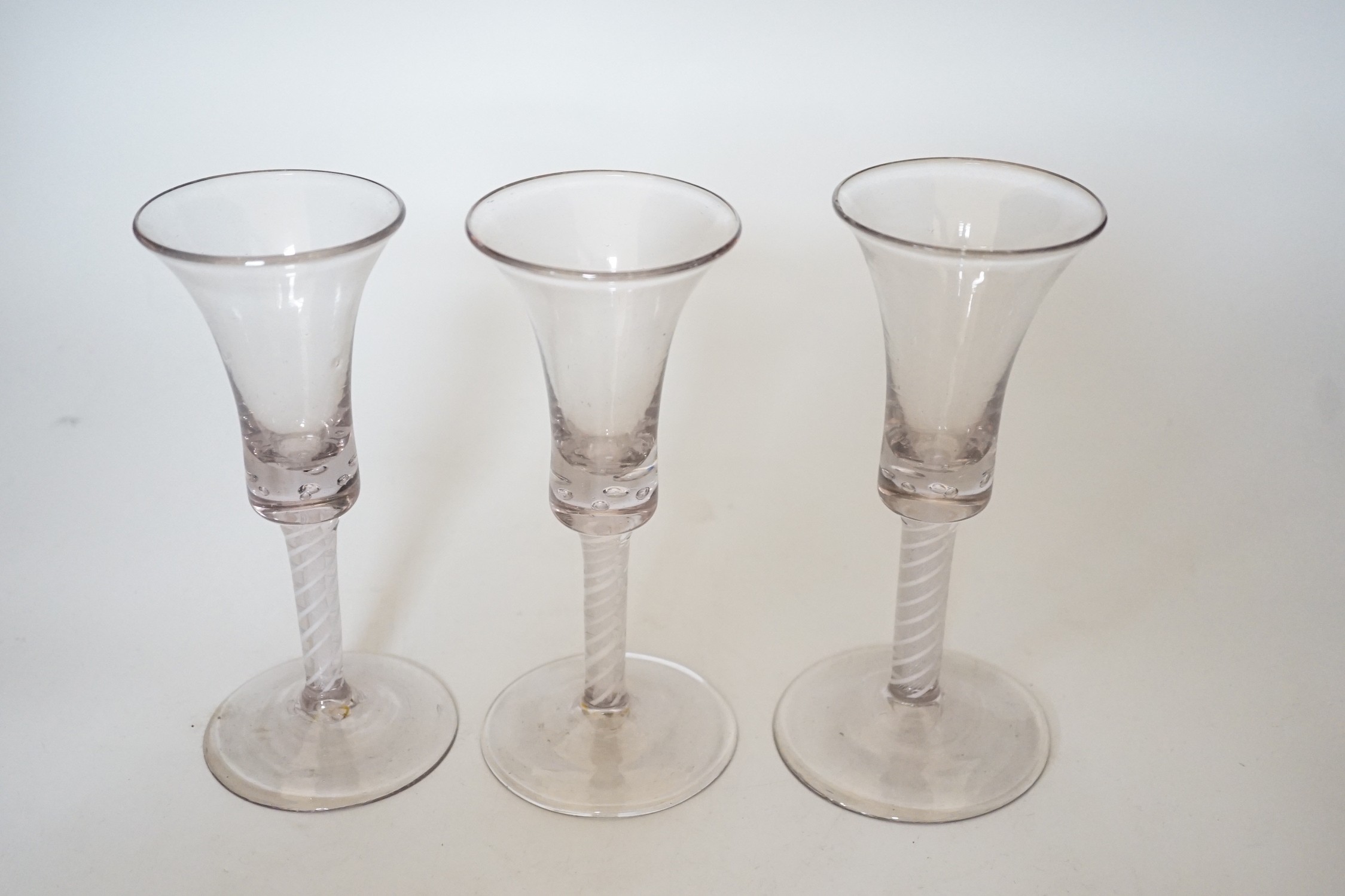 A trio of George III style cotton twist stemmed glasses, 17.5cms high